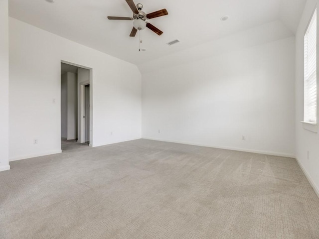 carpeted empty room with lofted ceiling and ceiling fan