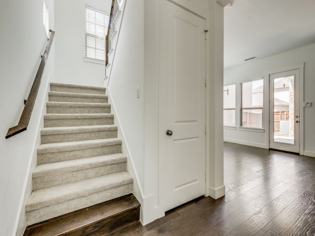 staircase featuring dark hardwood / wood-style flooring