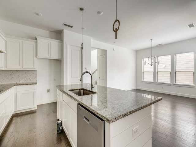 kitchen featuring sink, dishwasher, dark hardwood / wood-style flooring, and a kitchen island with sink