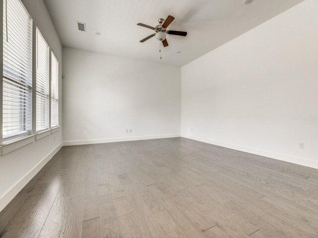 spare room featuring light hardwood / wood-style floors and ceiling fan