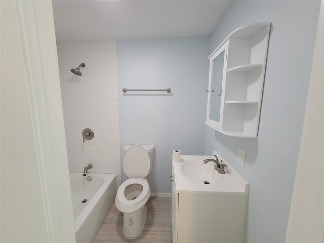 full bathroom with vanity, tiled shower / bath combo, toilet, and hardwood / wood-style floors