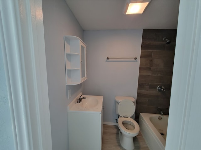 full bathroom with vanity, tiled shower / bath, and toilet