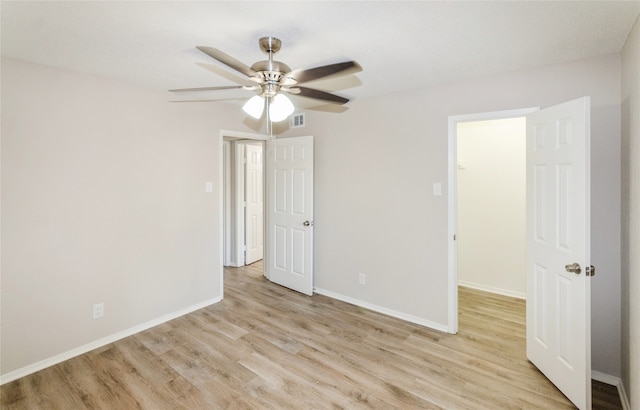 unfurnished bedroom with light hardwood / wood-style flooring and ceiling fan