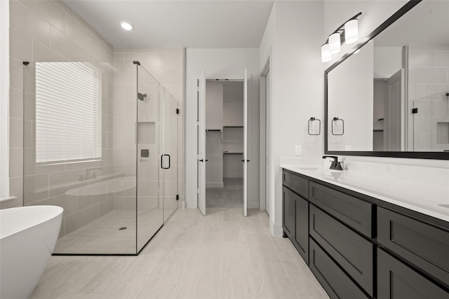 bathroom featuring vanity and shower with separate bathtub