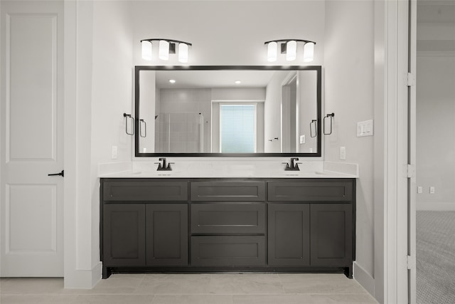 bathroom featuring tile patterned floors, a shower with shower door, and vanity