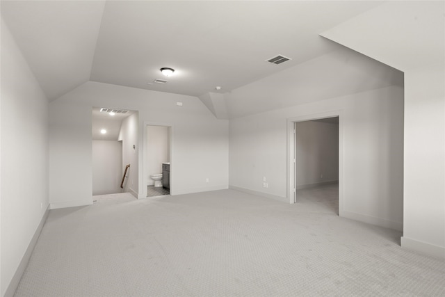 interior space featuring lofted ceiling and light colored carpet