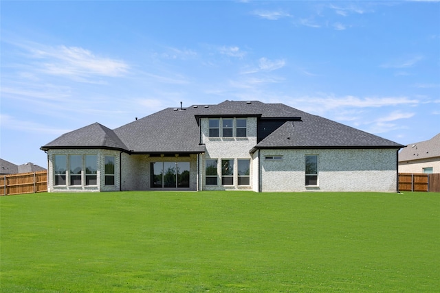 rear view of property featuring a yard