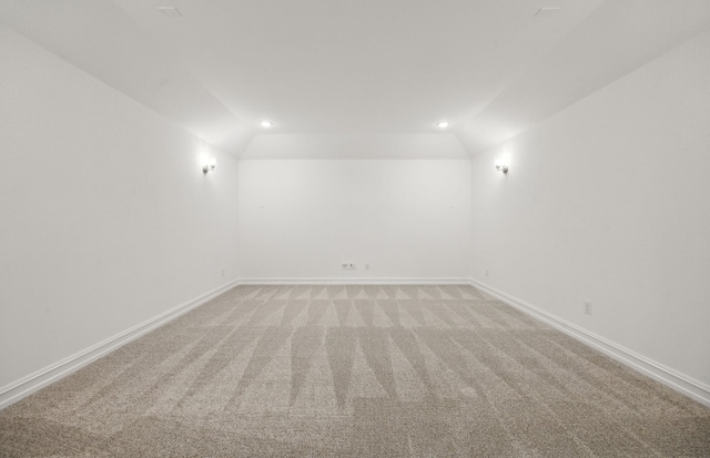 unfurnished room featuring carpet flooring and lofted ceiling