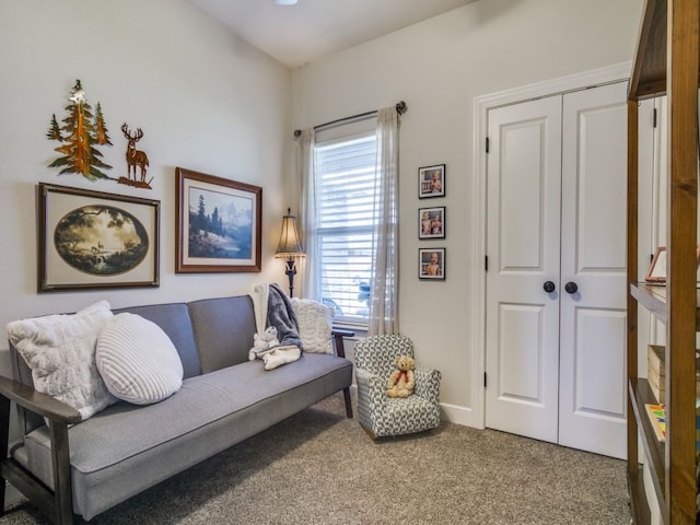 sitting room featuring carpet and baseboards