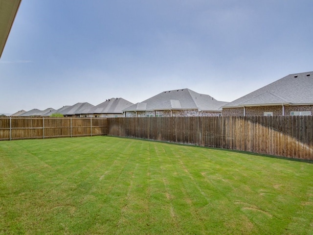 view of yard with a fenced backyard