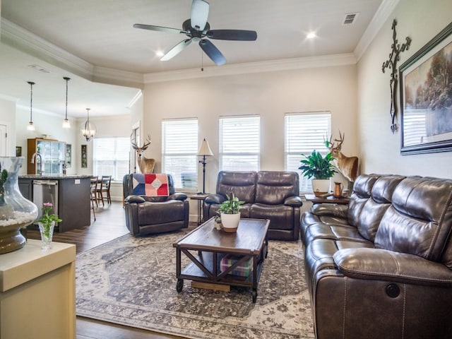 living room with sink, crown molding, dark hardwood / wood-style floors, and ceiling fan