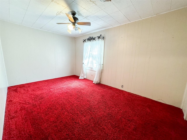 unfurnished room featuring carpet floors and a ceiling fan