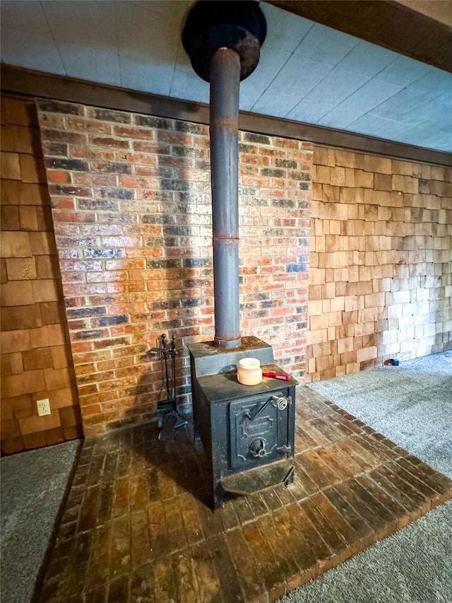 interior details featuring a wood stove and carpet