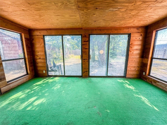 unfurnished sunroom featuring wood ceiling