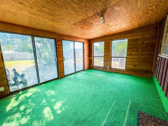 unfurnished sunroom with vaulted ceiling, wooden ceiling, and a wealth of natural light