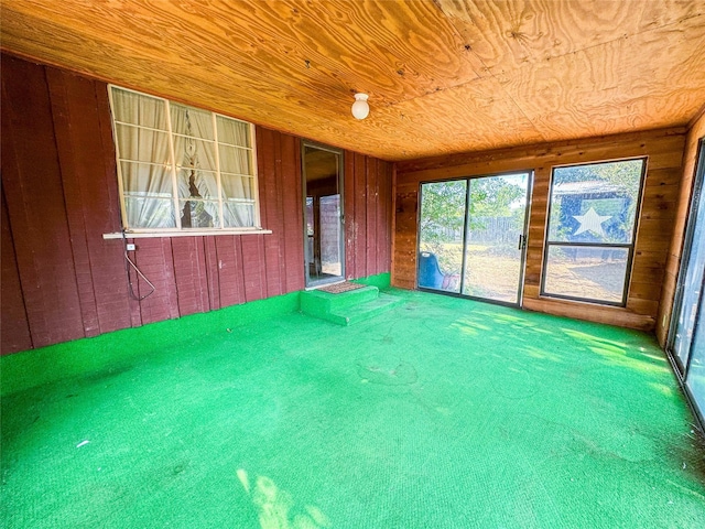 unfurnished sunroom featuring wood ceiling