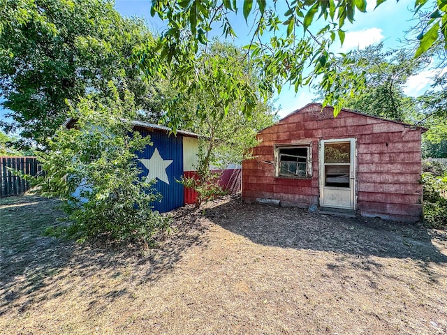 view of shed featuring fence