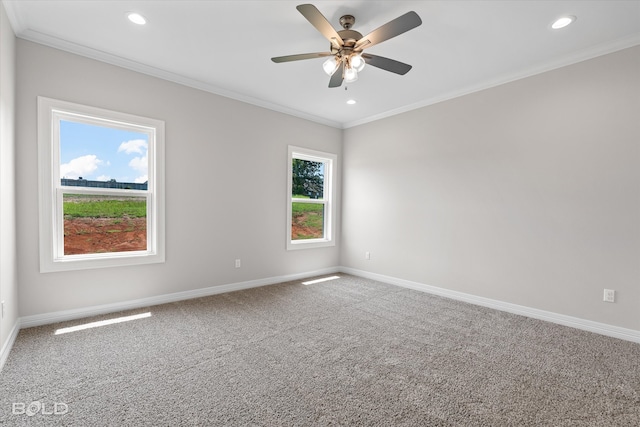 carpeted empty room featuring ceiling fan, ornamental molding, and a wealth of natural light