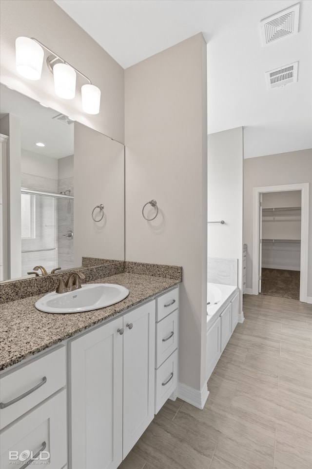 bathroom featuring tile patterned floors, vanity, ceiling fan, and independent shower and bath