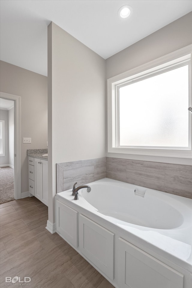 bathroom featuring vanity, a bathing tub, and tile patterned flooring