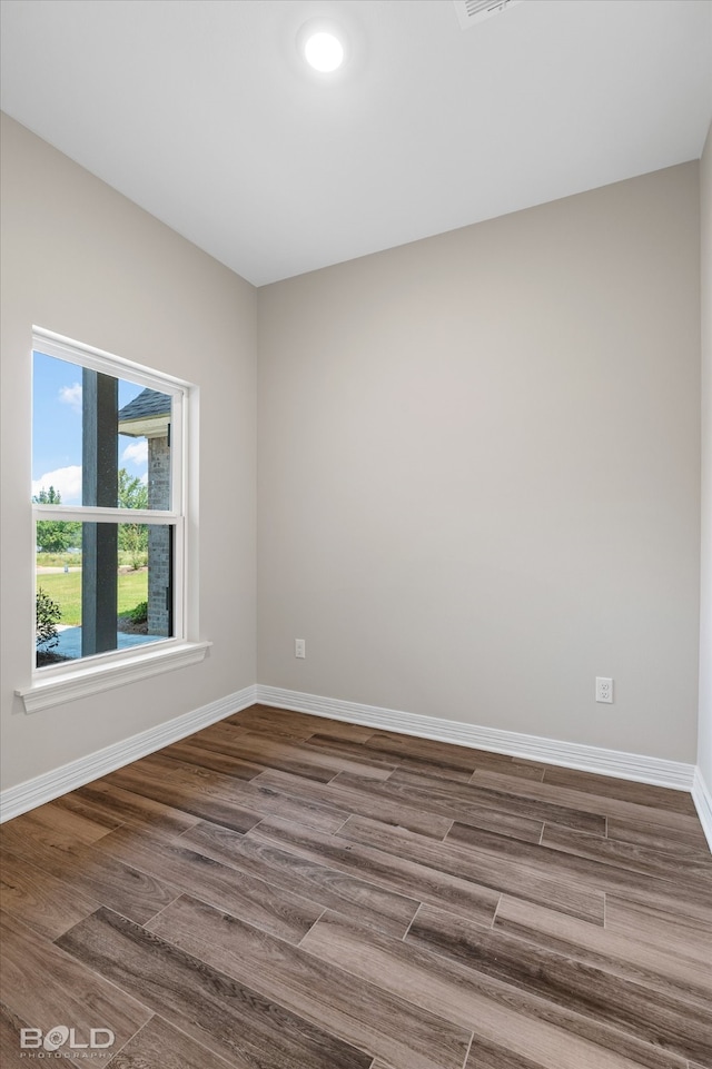 empty room with hardwood / wood-style flooring