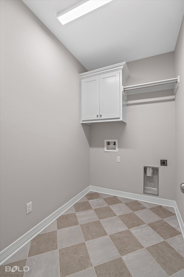 washroom with cabinets, light tile patterned flooring, and washer hookup