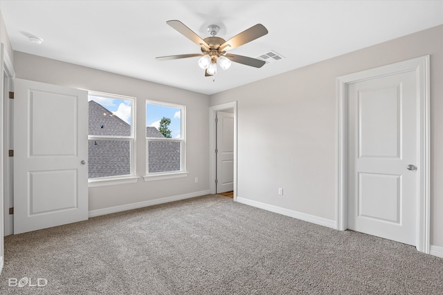 unfurnished bedroom featuring ceiling fan and carpet floors