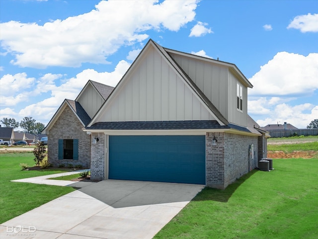 view of front facade with a front lawn, central AC unit, and a garage