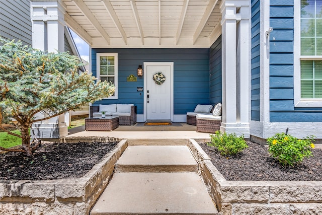 doorway to property featuring a patio area and outdoor lounge area