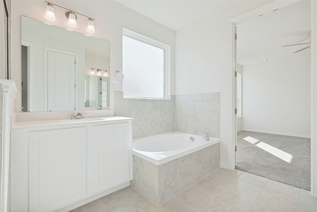 bathroom featuring vanity, ceiling fan, tile patterned floors, and tiled bath