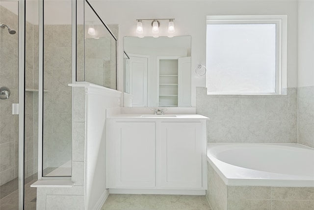 bathroom with vanity, tile patterned floors, and shower with separate bathtub