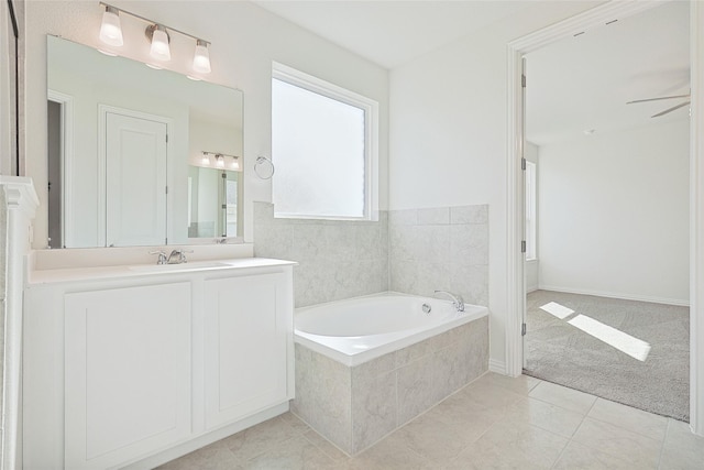 full bath with tile patterned flooring, ceiling fan, vanity, and a bath