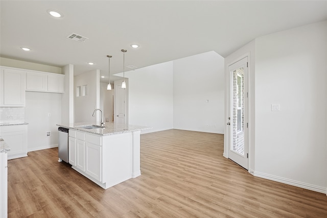 kitchen featuring light hardwood / wood-style flooring, white cabinetry, sink, and pendant lighting