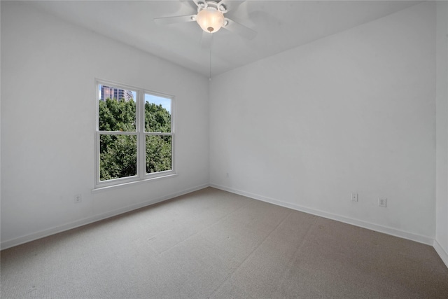 empty room featuring carpet floors, ceiling fan, and baseboards