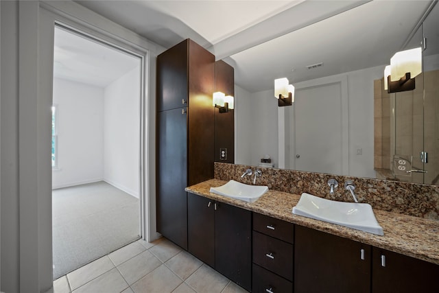 bathroom featuring dual vanity and tile patterned flooring