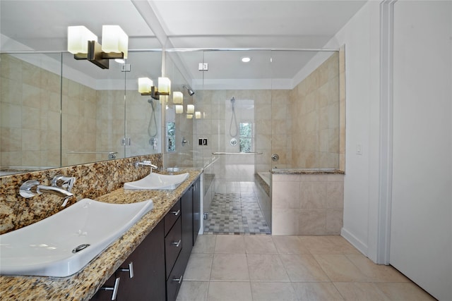 bathroom with dual vanity, an enclosed shower, tile patterned floors, and tile walls