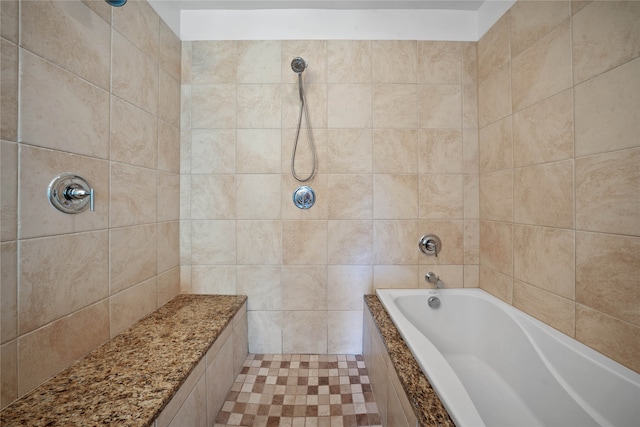 bathroom featuring tile walls and a tub to relax in