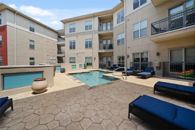 view of pool with an outdoor living space and a patio area