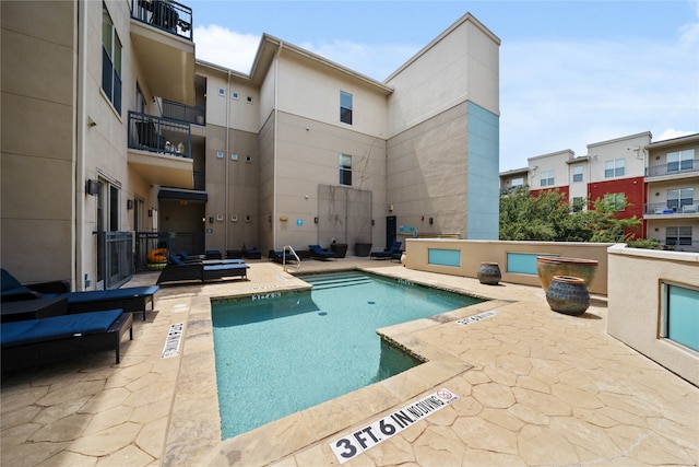 view of swimming pool with a patio