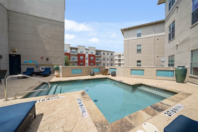 view of swimming pool featuring a patio area