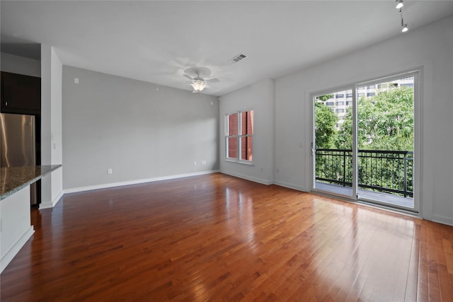 unfurnished living room featuring ceiling fan and hardwood / wood-style flooring