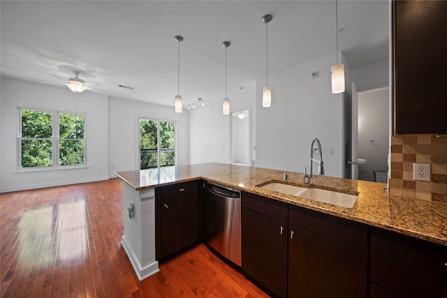 kitchen with stainless steel dishwasher, dark brown cabinets, kitchen peninsula, and hardwood / wood-style floors