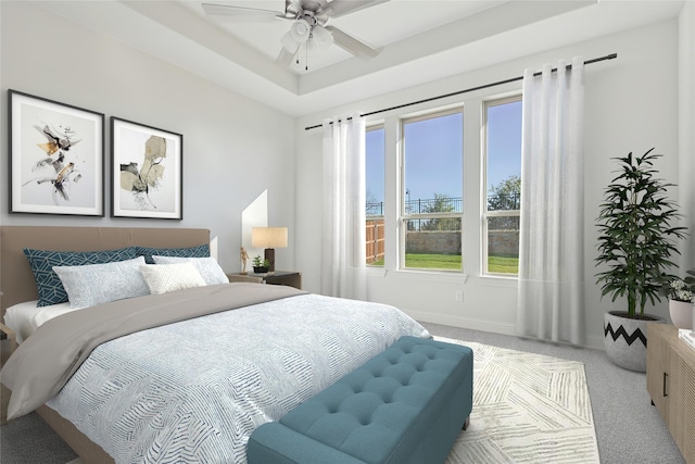 bedroom with light carpet, ceiling fan, baseboards, and a raised ceiling