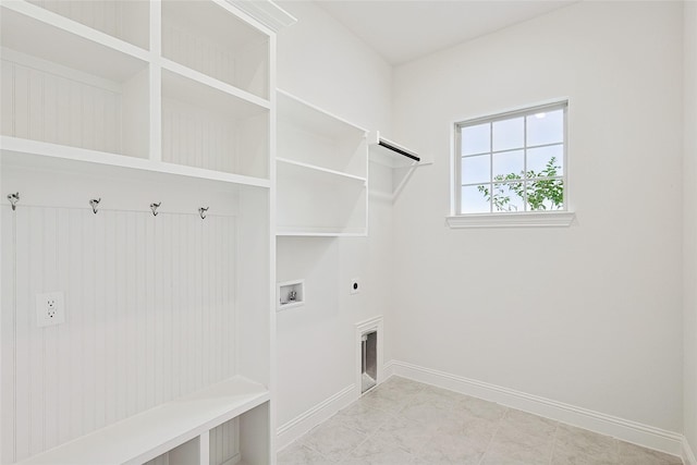 laundry room featuring laundry area, hookup for a washing machine, baseboards, and hookup for an electric dryer