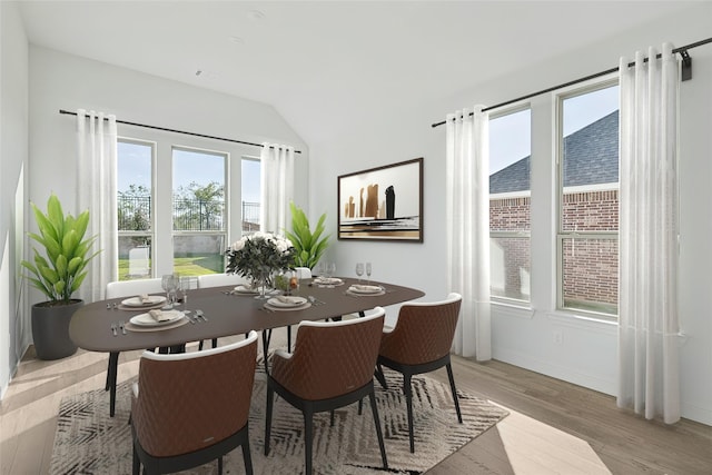 dining room with baseboards, lofted ceiling, and light wood-style floors