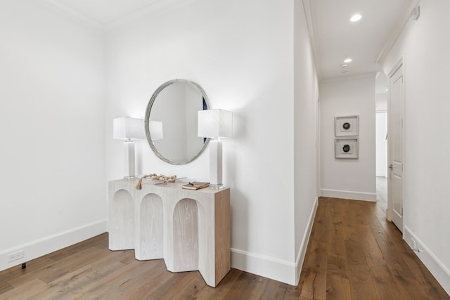 hallway featuring wood-type flooring and crown molding