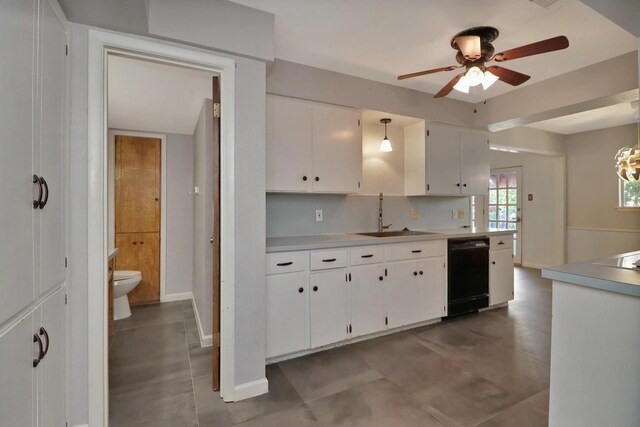 kitchen with decorative light fixtures, black dishwasher, sink, white cabinets, and ceiling fan