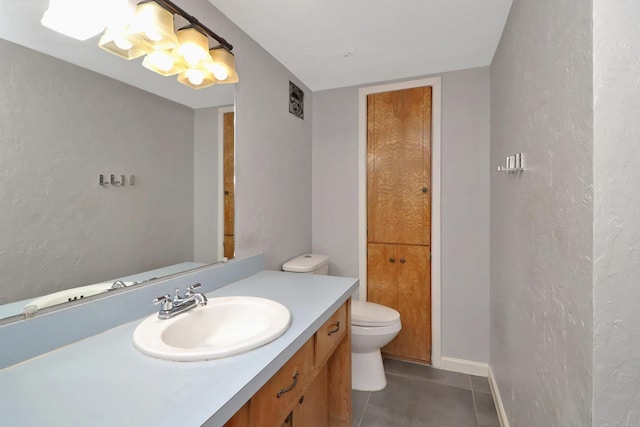 bathroom with vanity, tile patterned flooring, and toilet