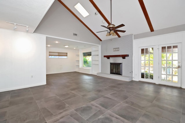 unfurnished living room with built in features, high vaulted ceiling, a fireplace, beamed ceiling, and ceiling fan