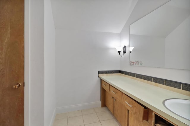 bathroom featuring tile patterned flooring, sink, and backsplash